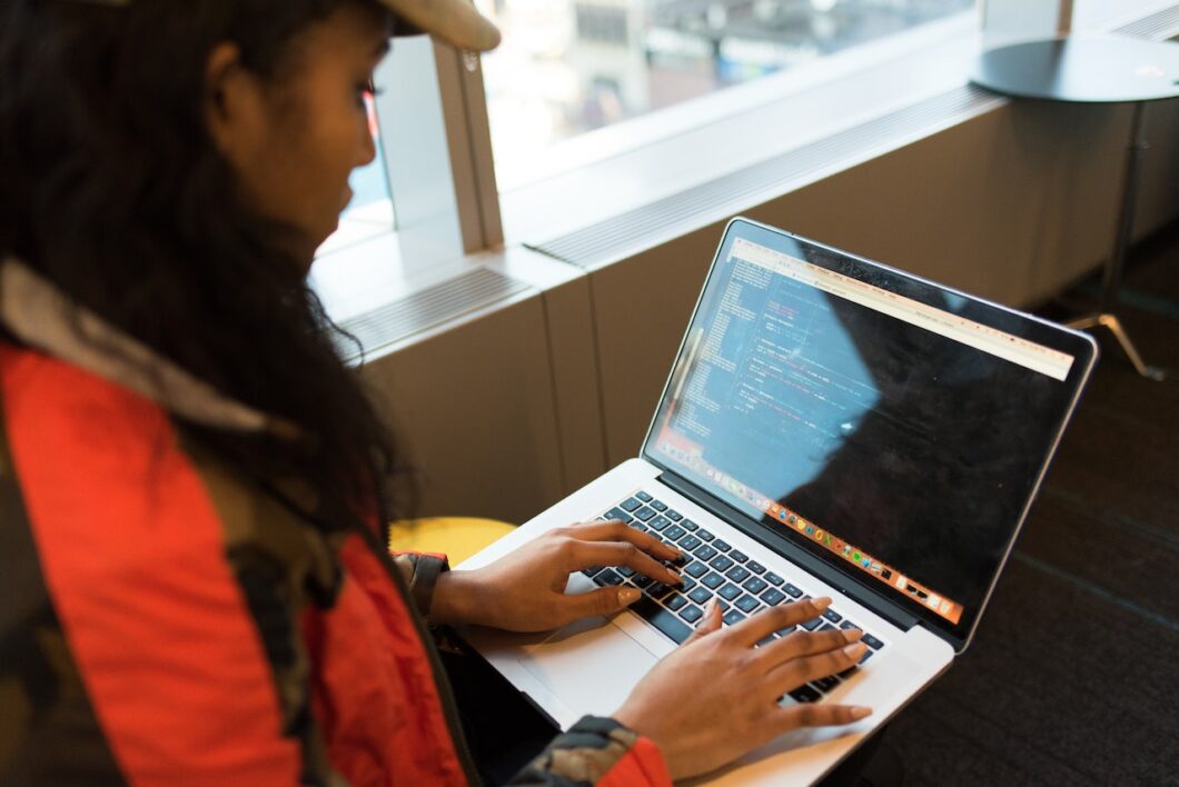 girl standing with laptop