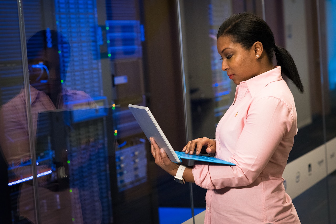 girl standing with laptop